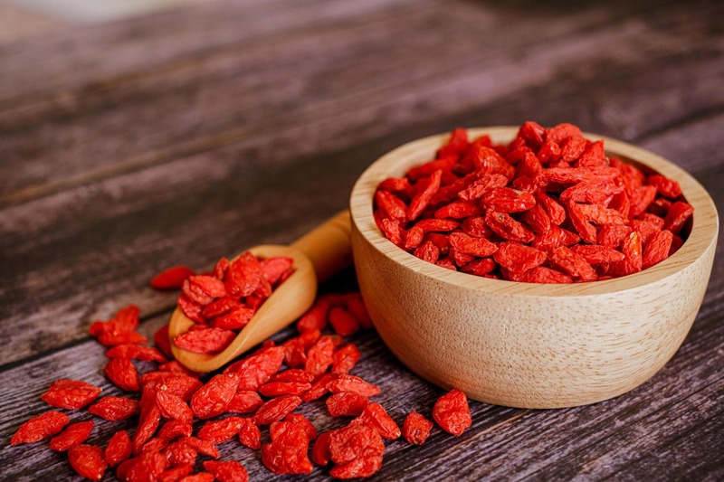 Gou Qi Zi — dried goji berries in a wooden bowl